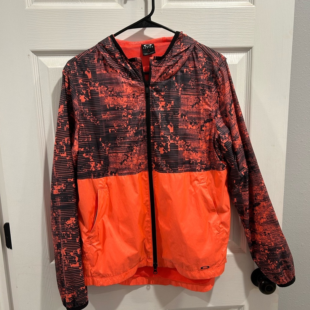 Oakley Vibrant orange an black hooded windbreaker/waterproof